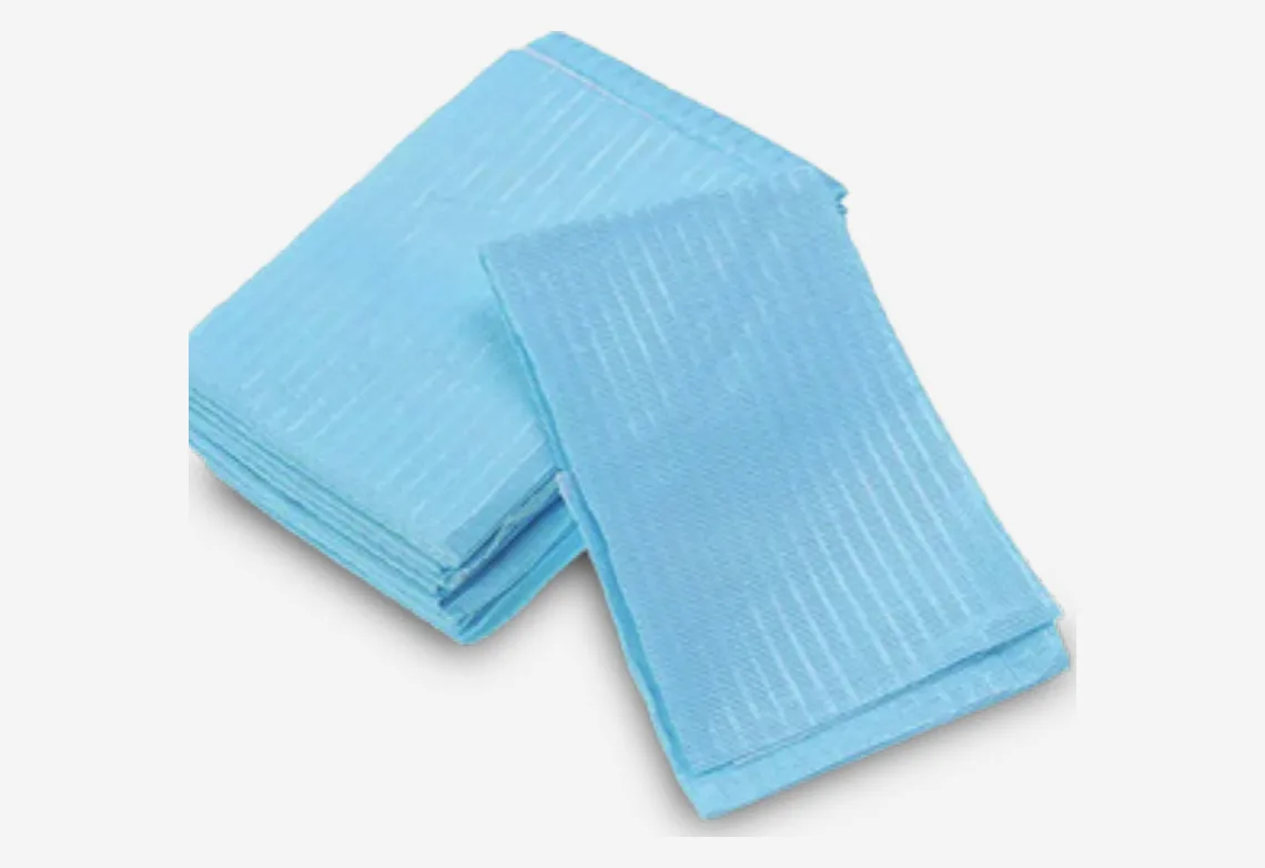 Stack of blue disposable dental bibs